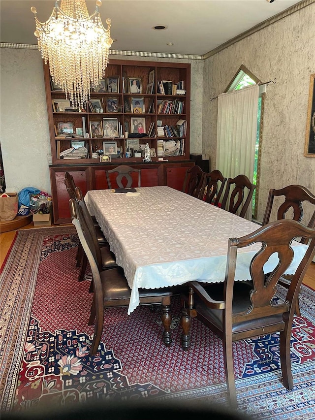 dining area featuring a chandelier and ornamental molding