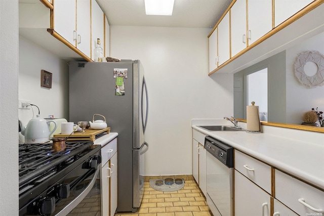 kitchen with black gas stove, white dishwasher, white cabinetry, and sink