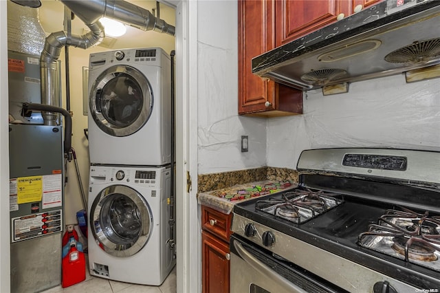 laundry room with light tile patterned floors and stacked washer and dryer