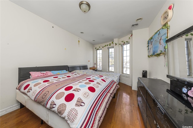 bedroom with dark hardwood / wood-style flooring