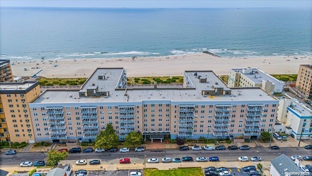 drone / aerial view with a water view and a view of the beach