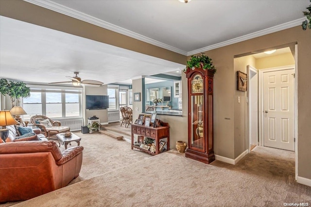 carpeted living room with ceiling fan and ornamental molding