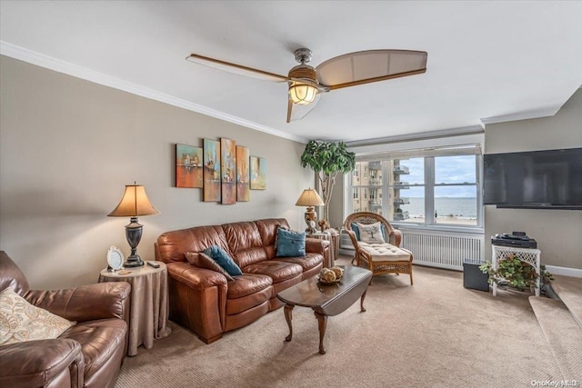 living room featuring ceiling fan, ornamental molding, carpet floors, and radiator