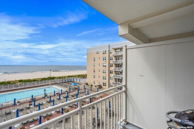 balcony with a water view and a beach view