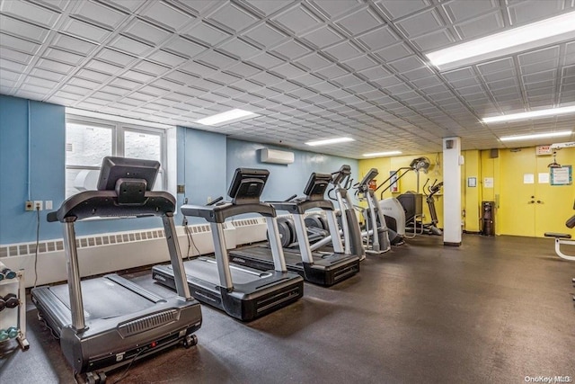 workout area featuring a wall mounted air conditioner