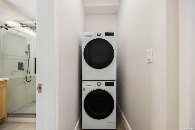 clothes washing area with stacked washer and clothes dryer