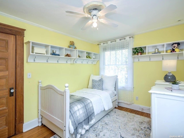 bedroom with ceiling fan, ornamental molding, and light wood-type flooring