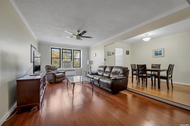 living room featuring ceiling fan, cooling unit, dark hardwood / wood-style flooring, and crown molding