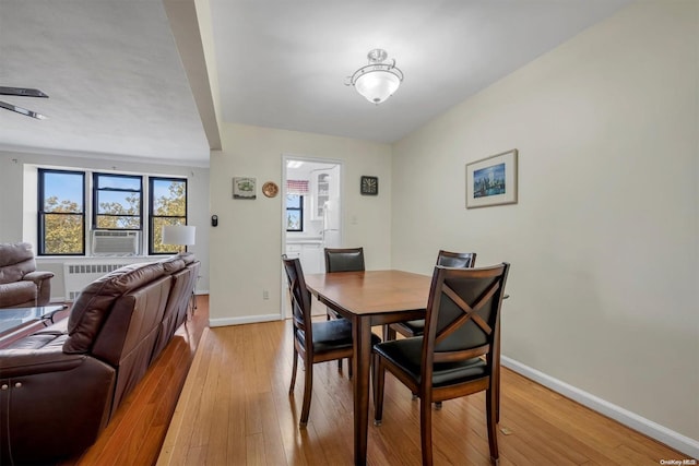 dining area featuring light hardwood / wood-style flooring and cooling unit