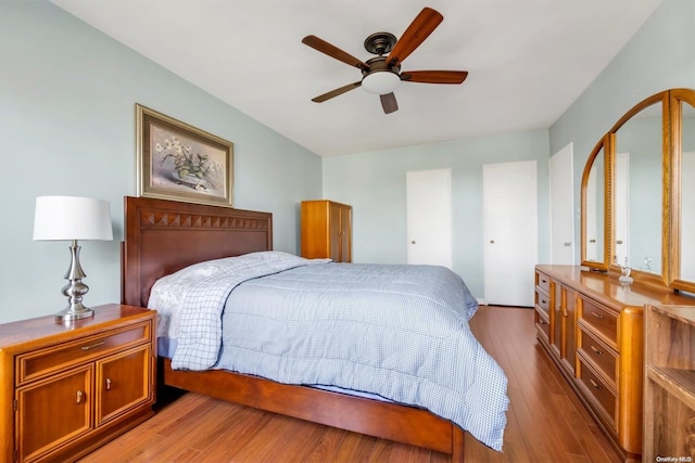 bedroom with light hardwood / wood-style flooring and ceiling fan