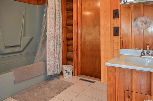 bathroom featuring log walls, vanity, tile patterned flooring, and shower / bath combo with shower curtain