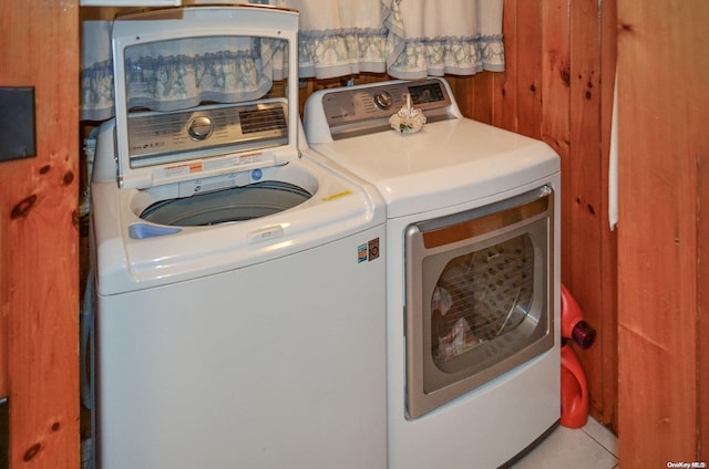 clothes washing area featuring tile patterned flooring and washing machine and dryer