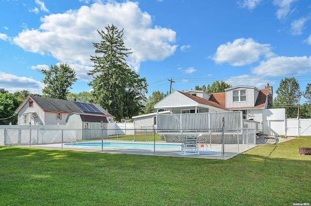 view of pool featuring a deck and a yard