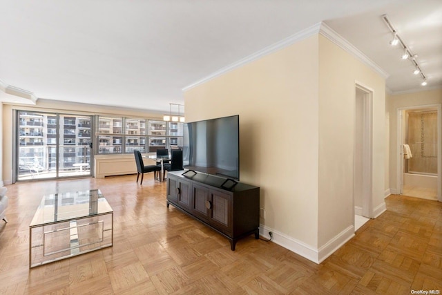 living room with ornamental molding, rail lighting, and light parquet floors