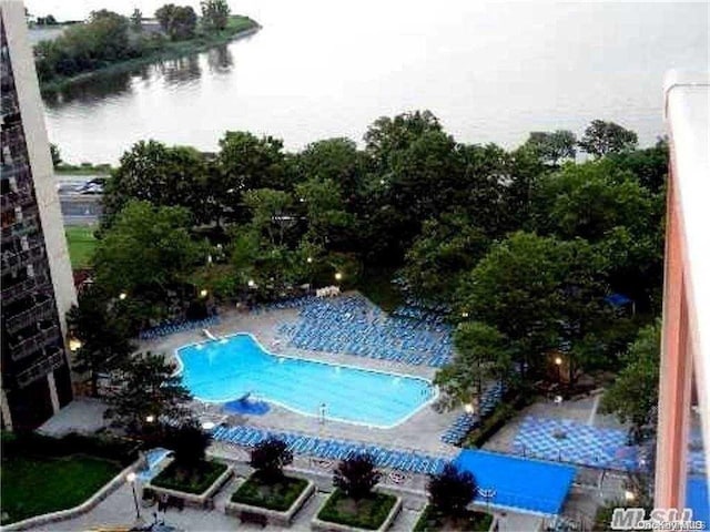 view of pool with a water view