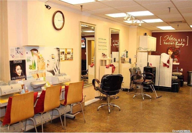 interior space featuring a drop ceiling and ornamental molding