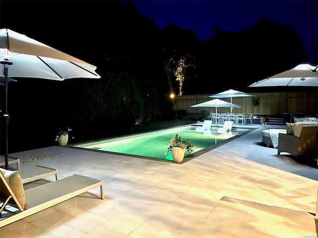 pool at night with a patio