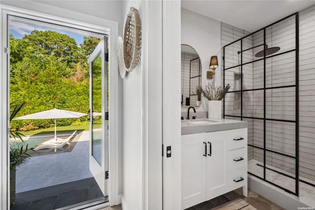 bathroom featuring a shower with door, vanity, and hardwood / wood-style flooring