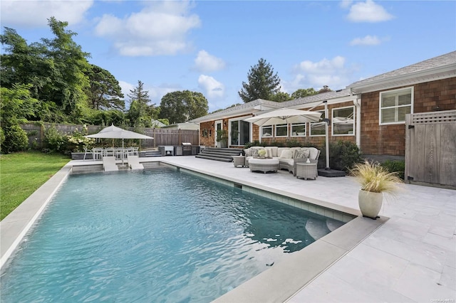 view of pool with an outdoor living space and a patio