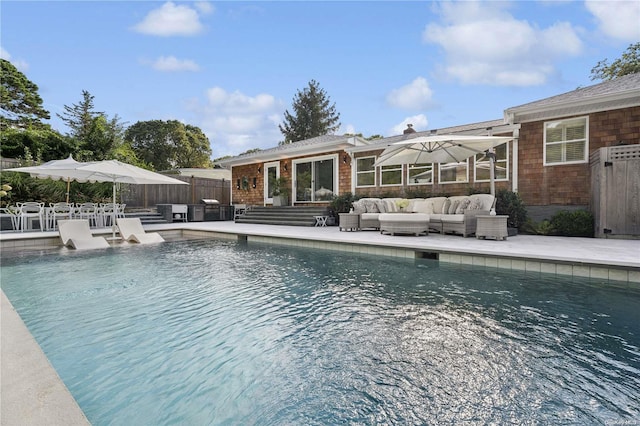 view of swimming pool with an outdoor living space and a patio area