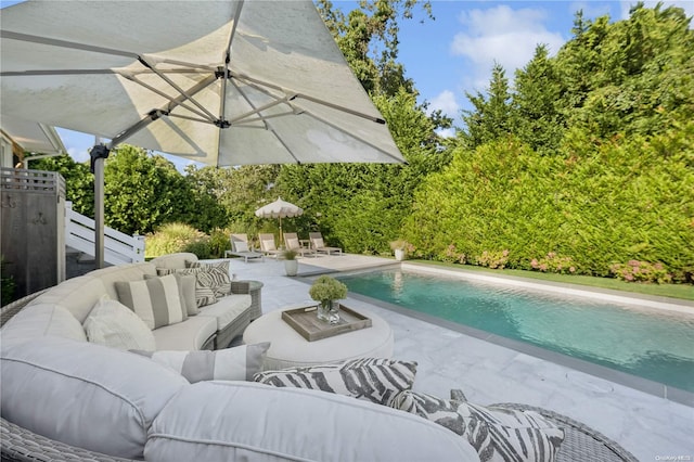 view of swimming pool featuring an outdoor living space and a patio