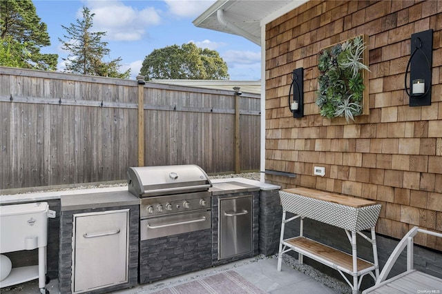 view of patio featuring grilling area and exterior kitchen