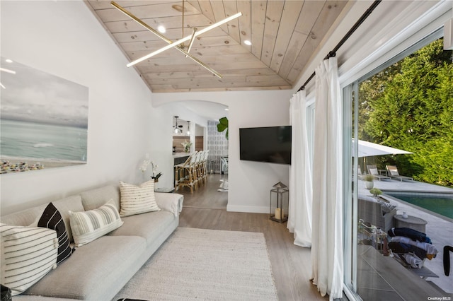 living room featuring hardwood / wood-style floors, vaulted ceiling, wooden ceiling, and a notable chandelier