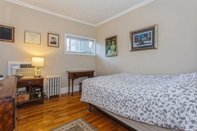 bedroom with dark hardwood / wood-style floors, ornamental molding, and radiator