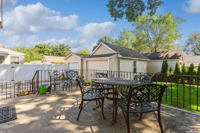 view of patio featuring an outbuilding and a garage