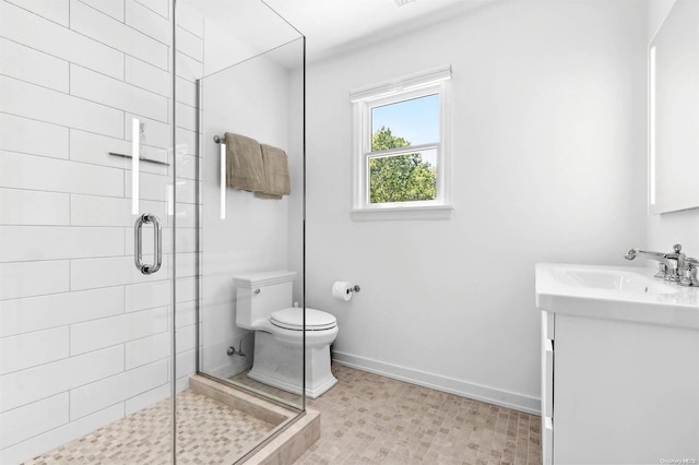 bathroom with vanity, toilet, and an enclosed shower