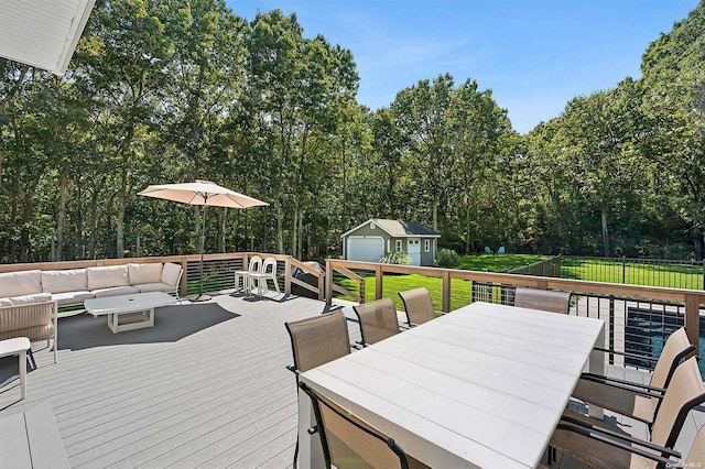 deck featuring a lawn, an outdoor hangout area, and an outdoor structure