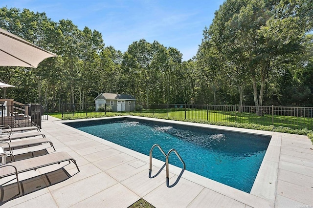 view of swimming pool featuring a patio area and a lawn