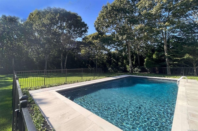 view of swimming pool with a yard