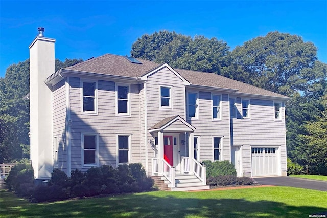 view of front facade with a front yard and a garage