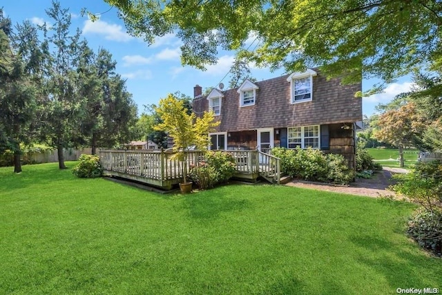 back of house featuring a wooden deck and a lawn