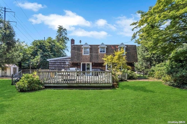 back of house with a yard and a deck