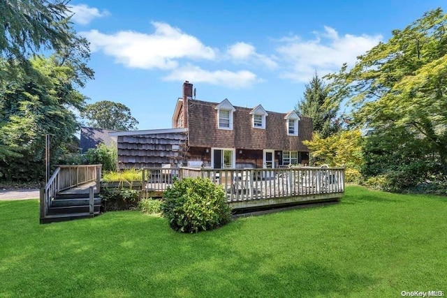 rear view of house with a yard and a deck