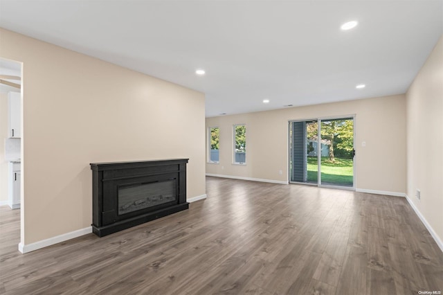 unfurnished living room featuring hardwood / wood-style flooring