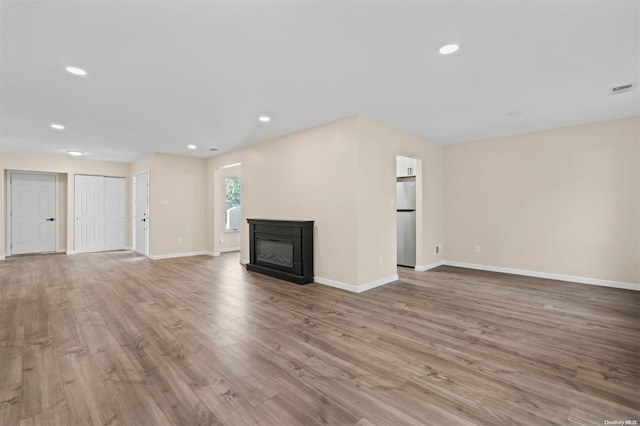 unfurnished living room with light hardwood / wood-style floors