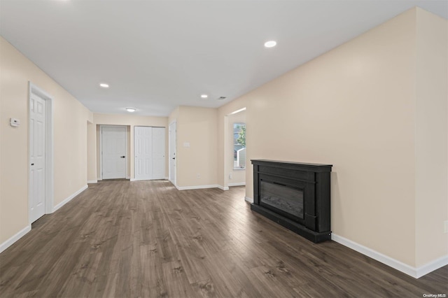 unfurnished living room with dark wood-type flooring