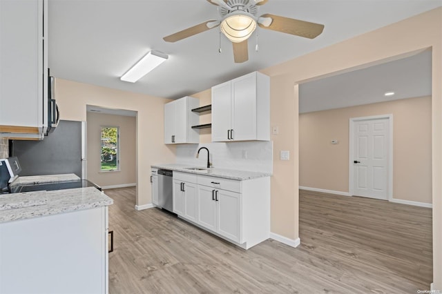 kitchen with white cabinets, stainless steel dishwasher, stove, and sink