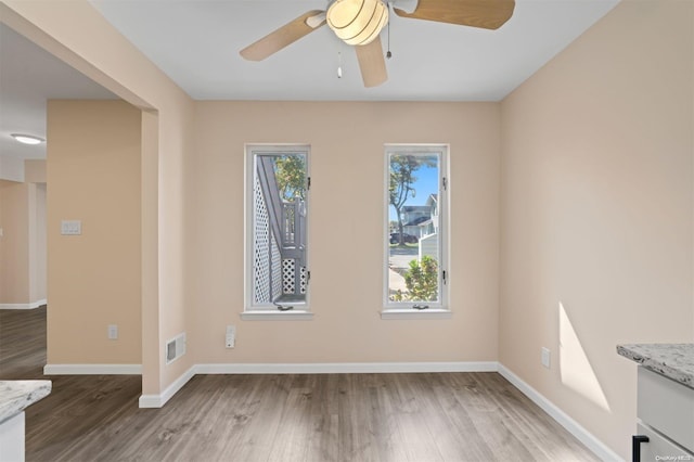 empty room featuring wood-type flooring and ceiling fan