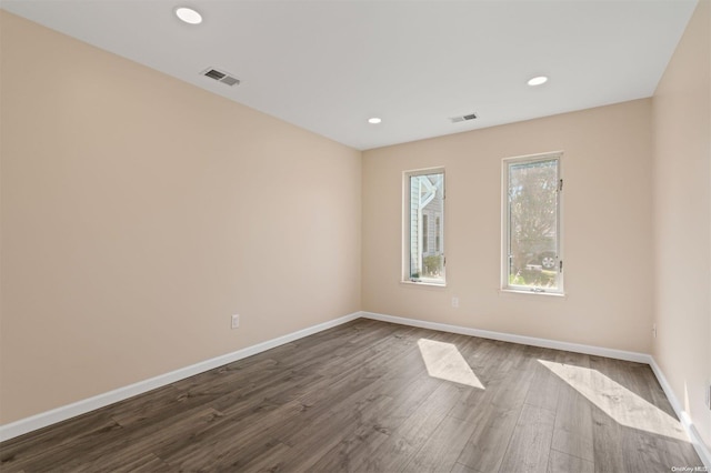 unfurnished room featuring dark wood-type flooring