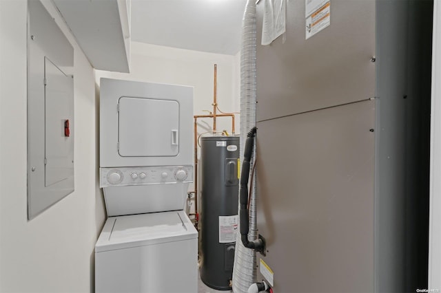 clothes washing area with stacked washer / dryer, electric panel, and water heater