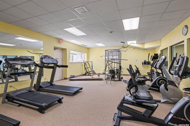 gym featuring carpet floors and a drop ceiling