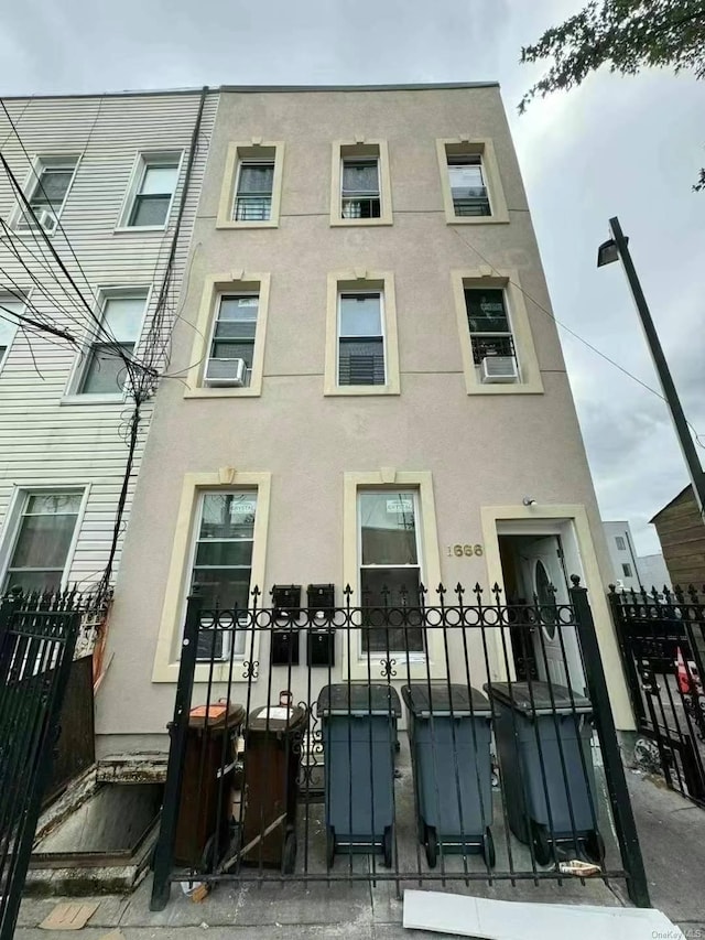 view of building exterior with fence