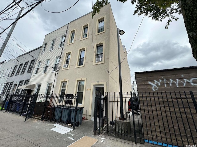 view of building exterior with a fenced front yard