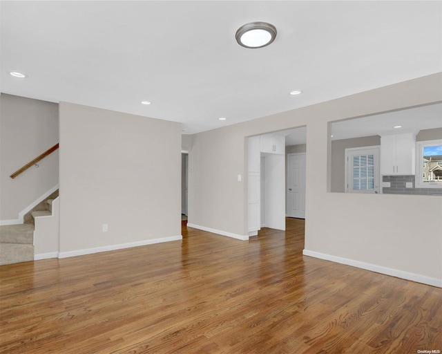 unfurnished living room featuring hardwood / wood-style floors