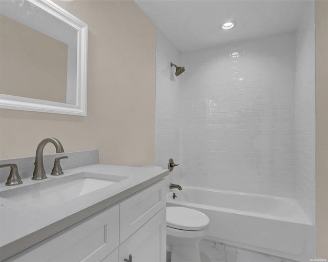 full bathroom featuring tiled shower / bath, vanity, and toilet