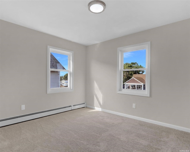 unfurnished room featuring baseboard heating, light carpet, and a healthy amount of sunlight